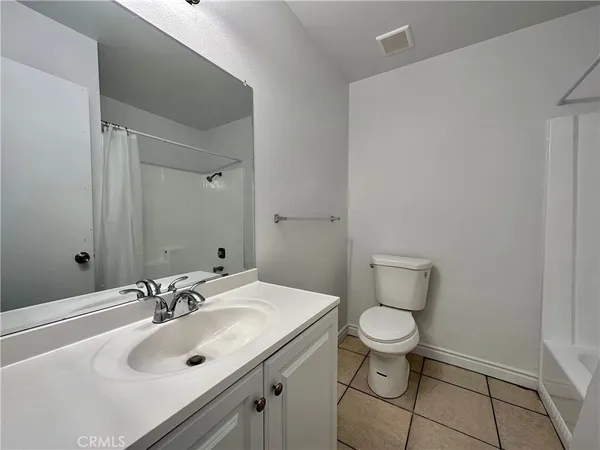 a bathroom with a sink toilet and a mirror
