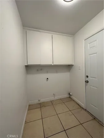 a view of a kitchen with white cabinets