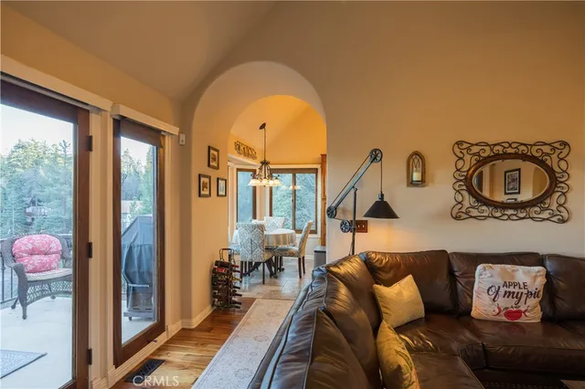 a living room with furniture and a floor to ceiling window