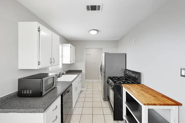 a kitchen with a sink stove and refrigerator
