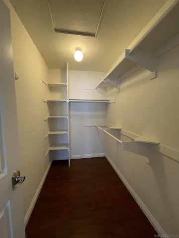 a view of walk in closet with empty racks