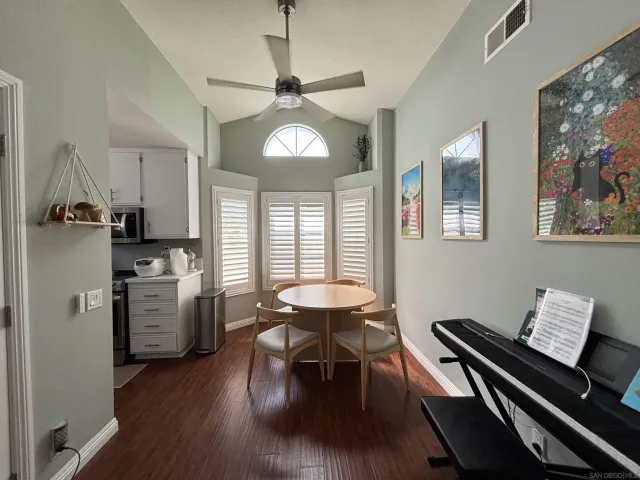 a kitchen with stainless steel appliances kitchen island granite countertop a stove top oven a refrigerator with island and chairs