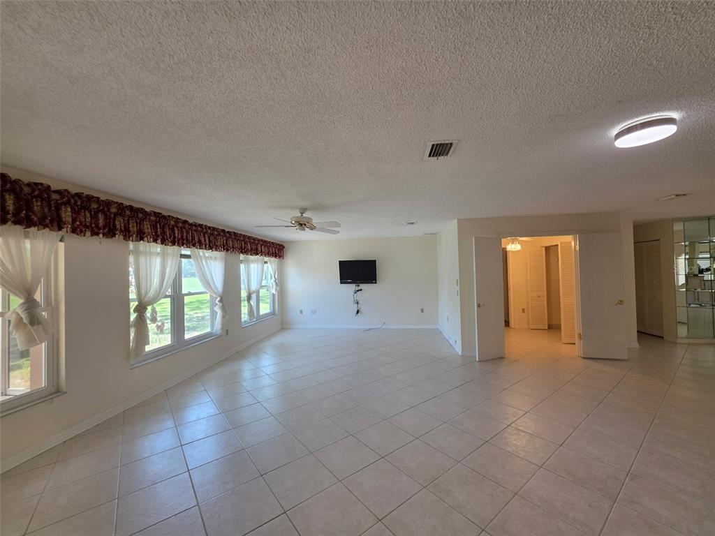 2376 Bent Pine Court Spring Hill, FL 34606 - Photo 4 of 33 a view of a big room with windows and chandelier