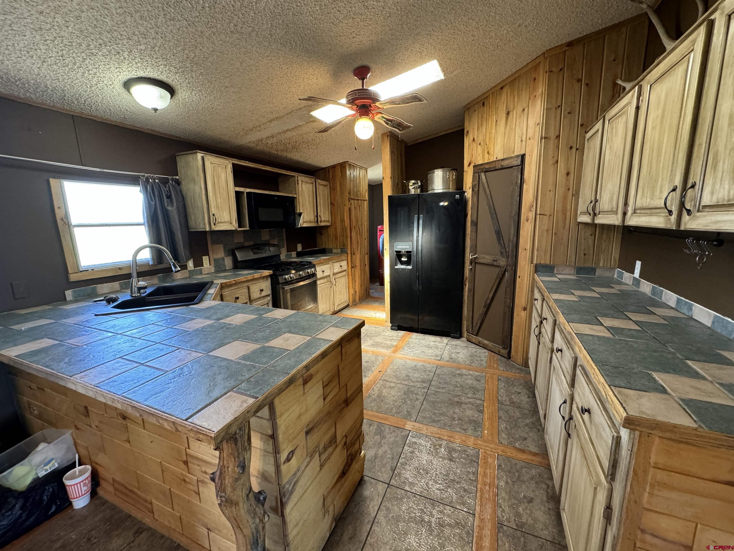 5538 West County Road 10 Del Norte, CO 81132 - Photo 13 of 34 a kitchen with a stove a refrigerator and a sink