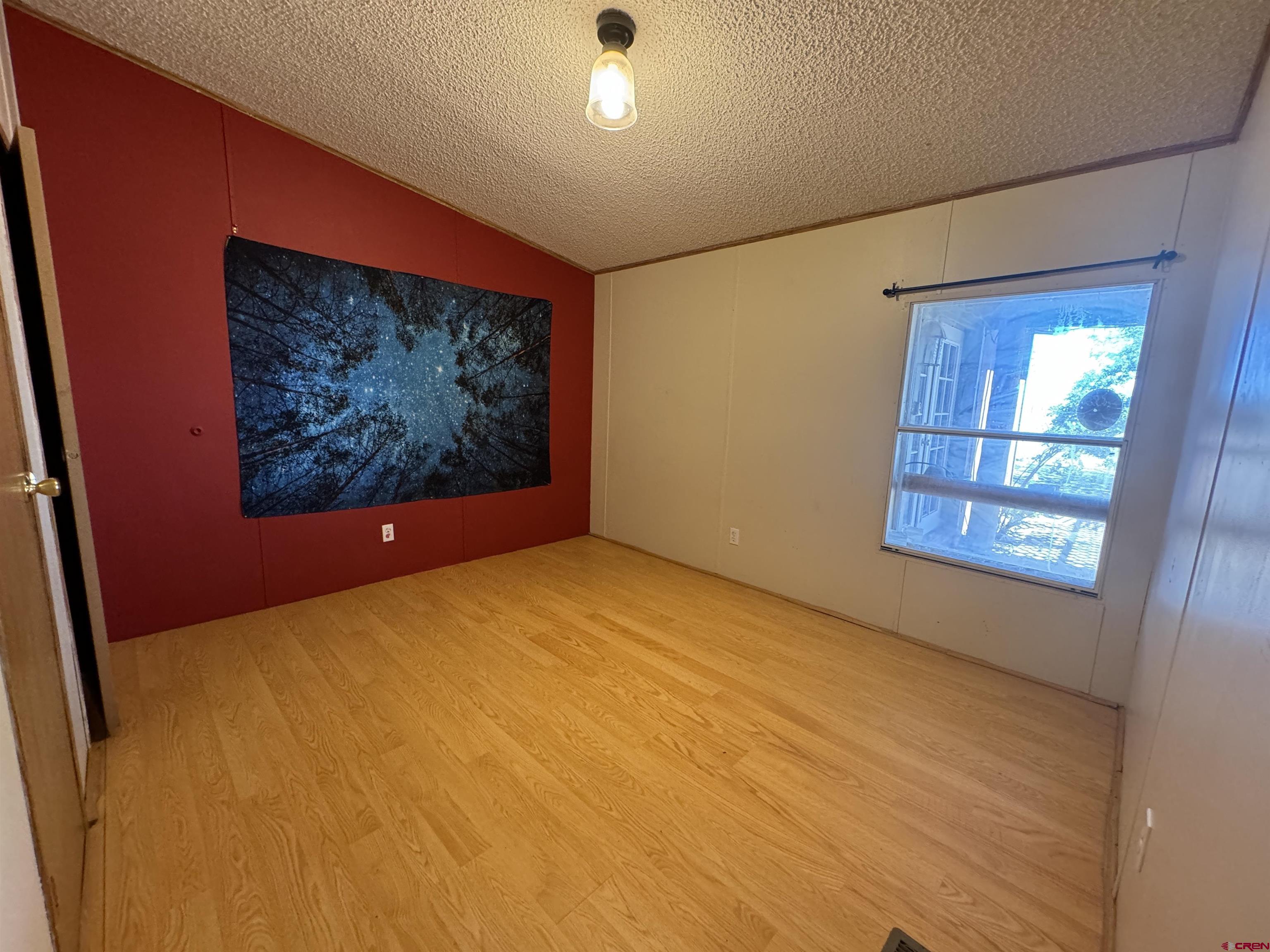 5538 West County Road 10 Del Norte, CO 81132 - Photo 15 of 34 a view of an empty room with window and wooden floor
