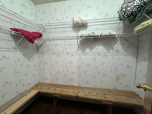 a bathroom with a granite countertop sink toilet and mirror