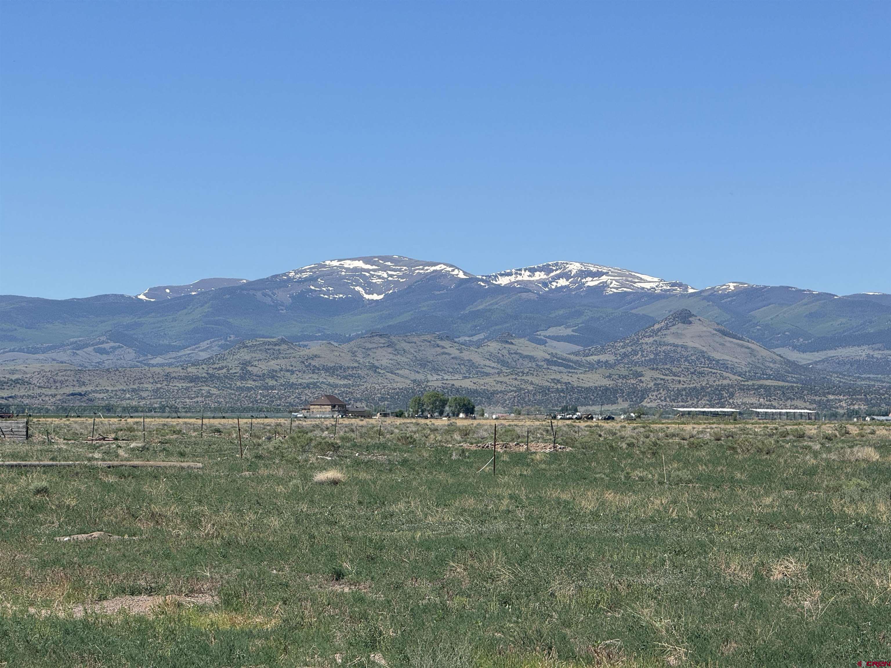 5538 West County Road 10 Del Norte, CO 81132 - Photo 3 of 34 a view of a lush green hillside and a houses