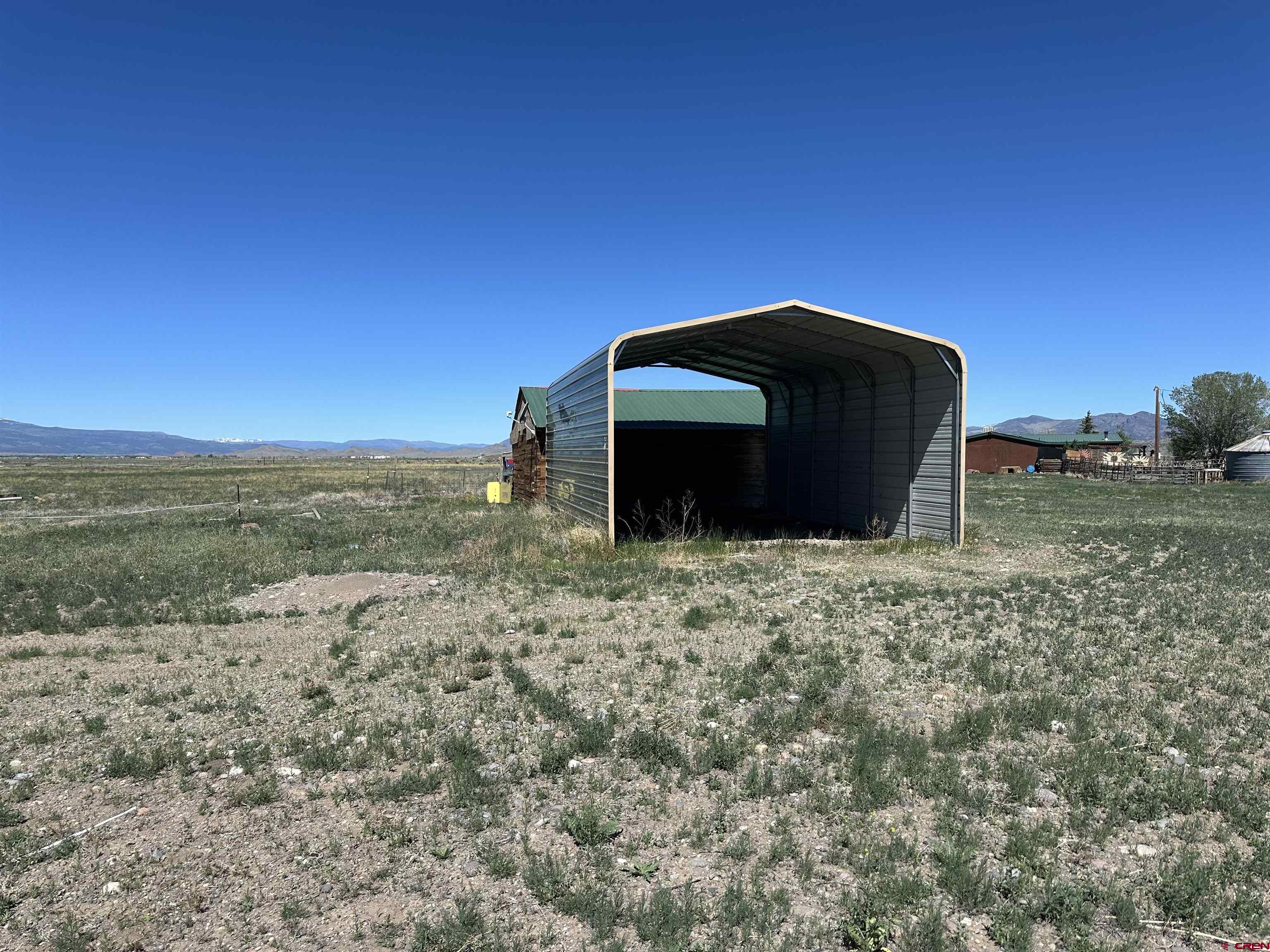 5538 West County Road 10 Del Norte, CO 81132 - Photo 32 of 34 a view of a barn in the middle of a field