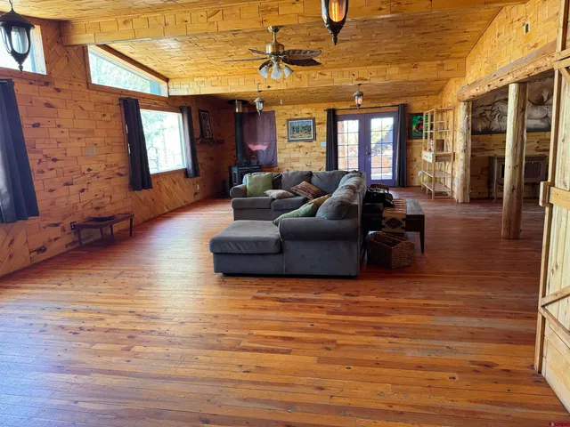 a view of a a dining room with furniture wooden floor and a chandelier