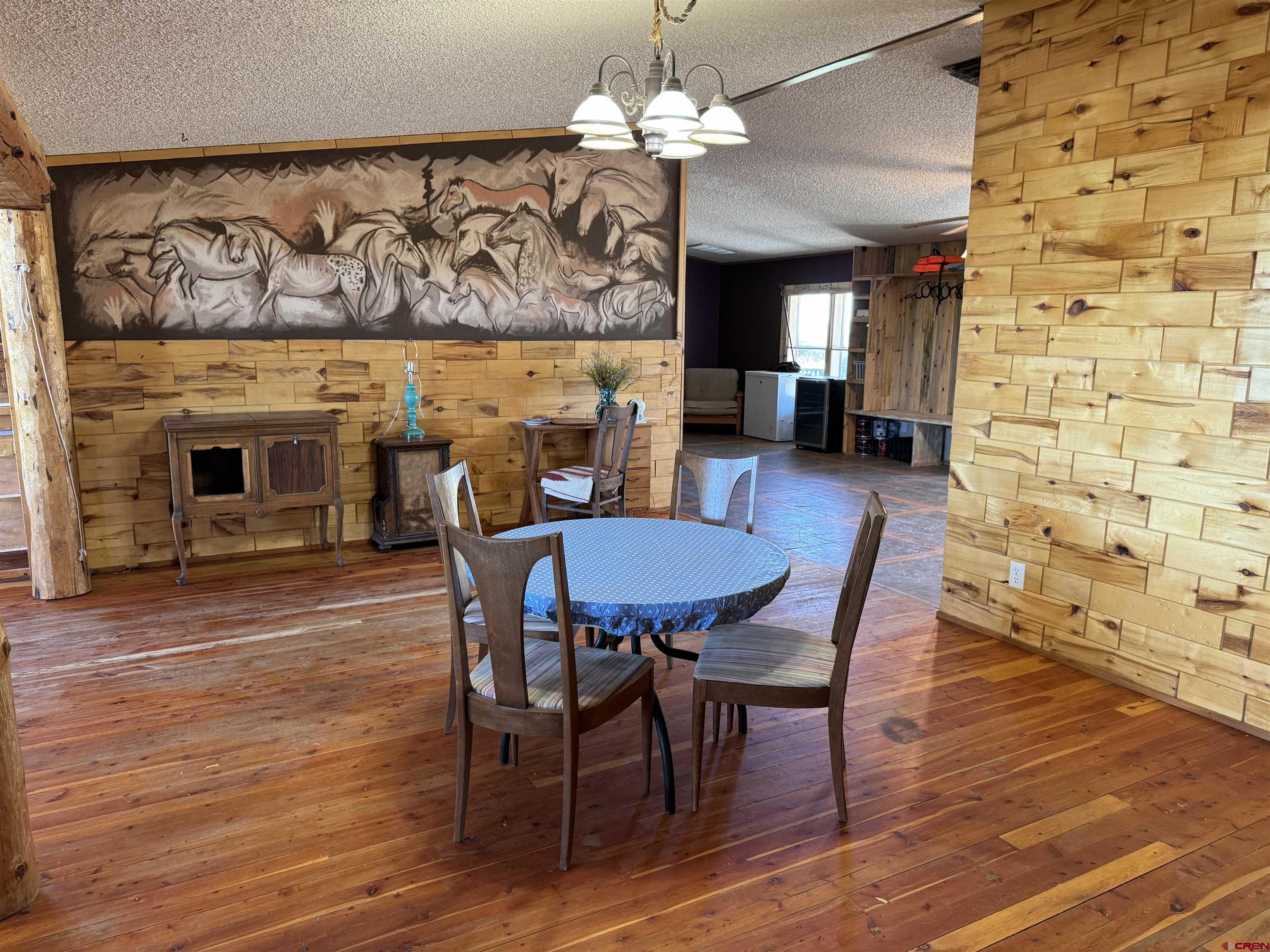 5538 West County Road 10 Del Norte, CO 81132 - Photo 10 of 34 a view of a a dining room with furniture wooden floor and a chandelier