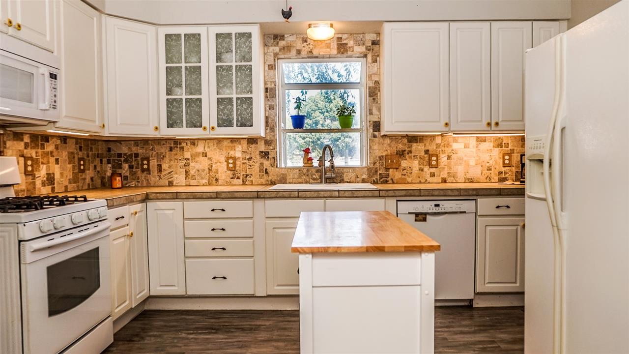 934 20 Road Fruita, CO 81521 - Photo 5 of 42 a kitchen with granite countertop white cabinets and white appliances