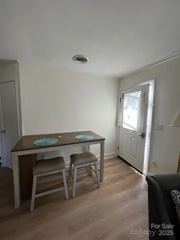 a view of room with window and a wooden floor