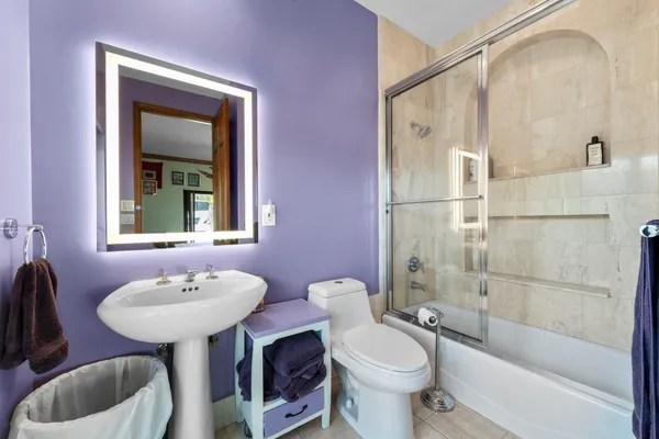 a bathroom with a sink toilet and shower