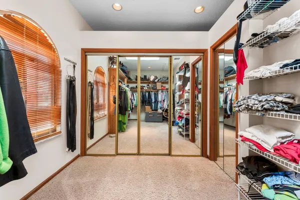 a spacious bathroom with double vanity a mirror a bathtub and double vanity