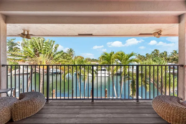 a view of balcony with couches wooden floor