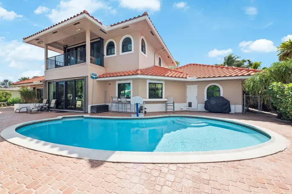 a view of a swimming pool with an outdoor seating