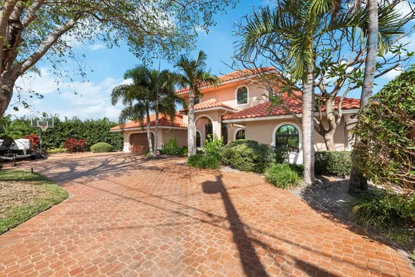 a front view of a house with yard and green space