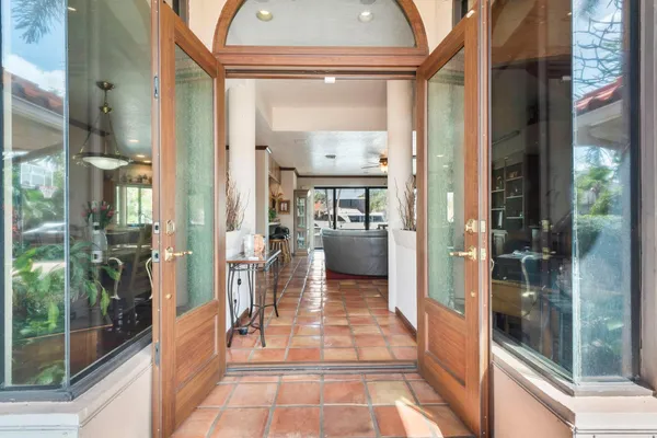 a view of a hallway with a glass door and a glass door