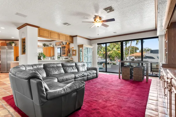 a living room with furniture large windows with wooden floor