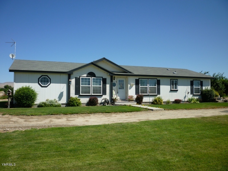 1411 Independence Road Outlook, WA 98938 - Photo 1 of 18 a front view of a house with a garden and porch