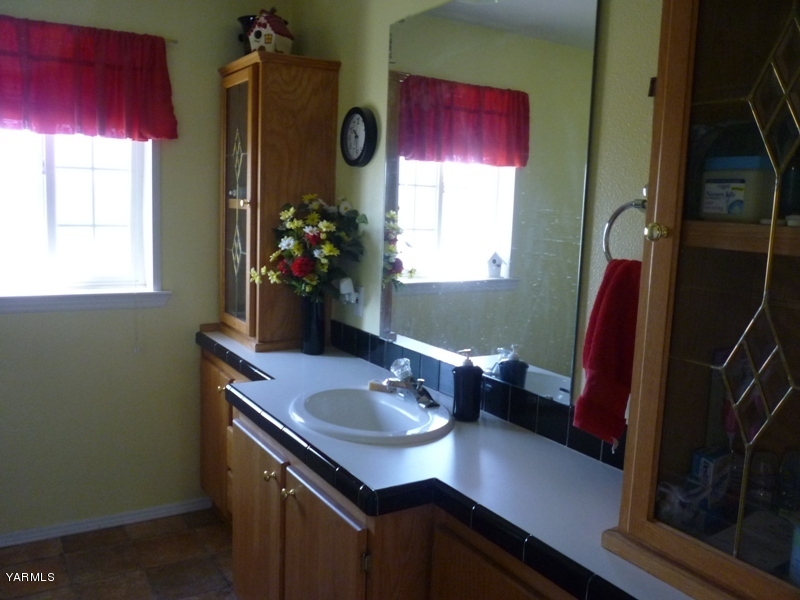 1411 Independence Road Outlook, WA 98938 - Photo 11 of 18 a bathroom with a sink vanity and a mirror
