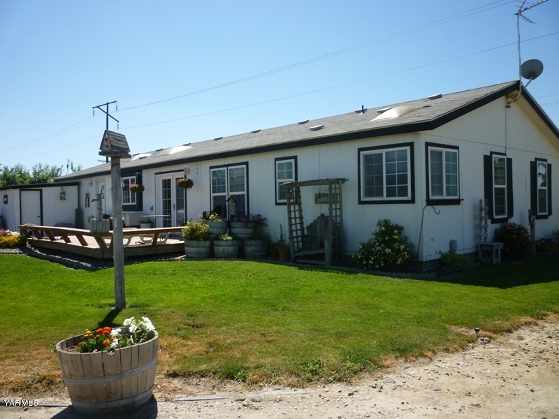 1411 Independence Road Outlook, WA 98938 - Photo 13 of 18 a front view of a house with garden and plants