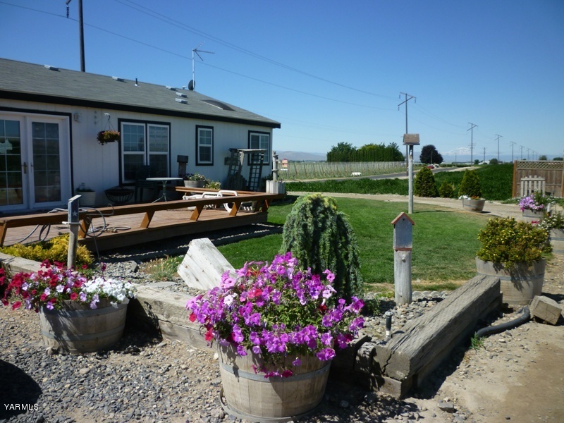 1411 Independence Road Outlook, WA 98938 - Photo 15 of 18 a view of a house with a backyard and sitting area