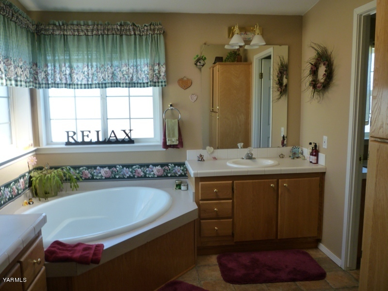 1411 Independence Road Outlook, WA 98938 - Photo 9 of 18 a bathroom with a tub sink and mirror