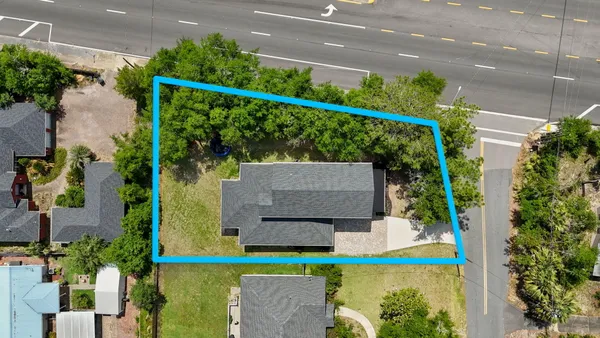 an aerial view of a house with a garden and plants