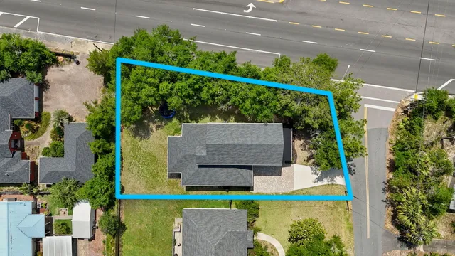 an aerial view of a house with a garden and plants