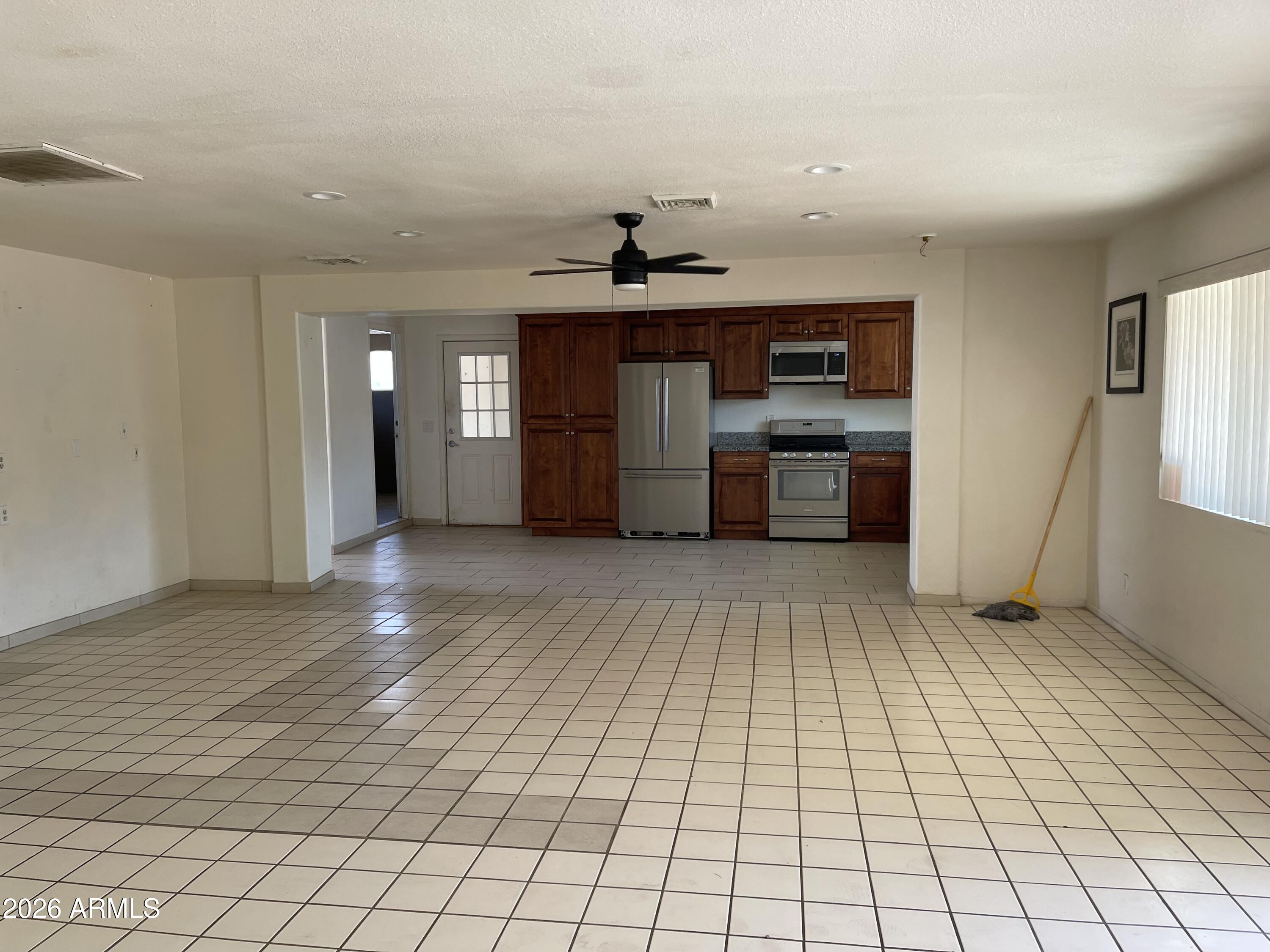 520 West McNeil Street Phoenix, AZ 85041 - Photo 18 of 18 a view of empty room with wooden floor and window