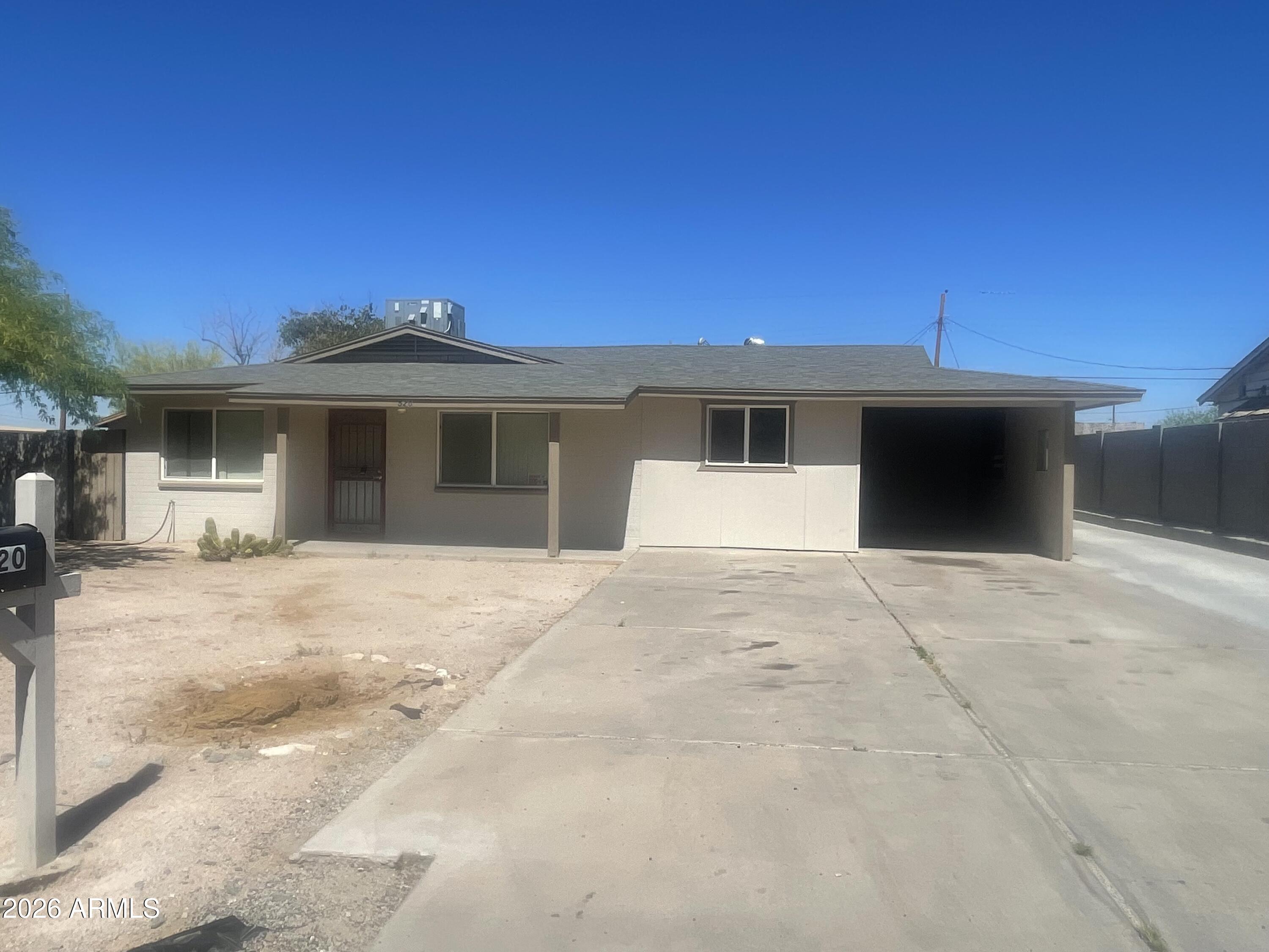 520 West McNeil Street Phoenix, AZ 85041 - Photo 4 of 18 a front view of a house with a garage