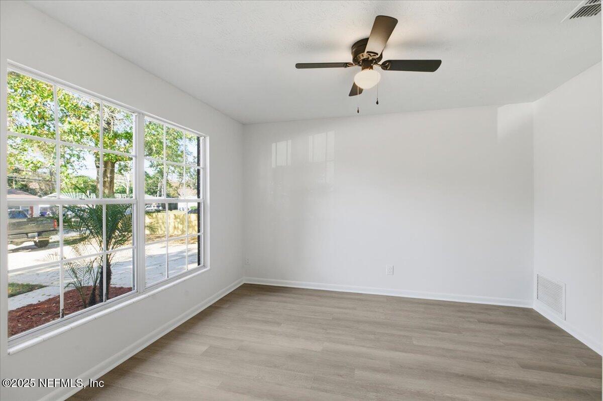 3767 Heath Road Jacksonville, FL 32277 - Photo 11 of 23 a view of room with a window and a ceiling fan