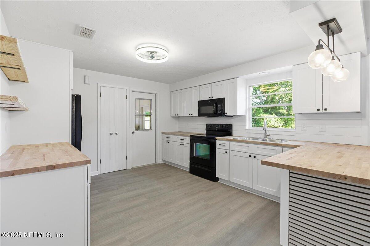 3767 Heath Road Jacksonville, FL 32277 - Photo 12 of 23 a kitchen with a sink stove and refrigerator
