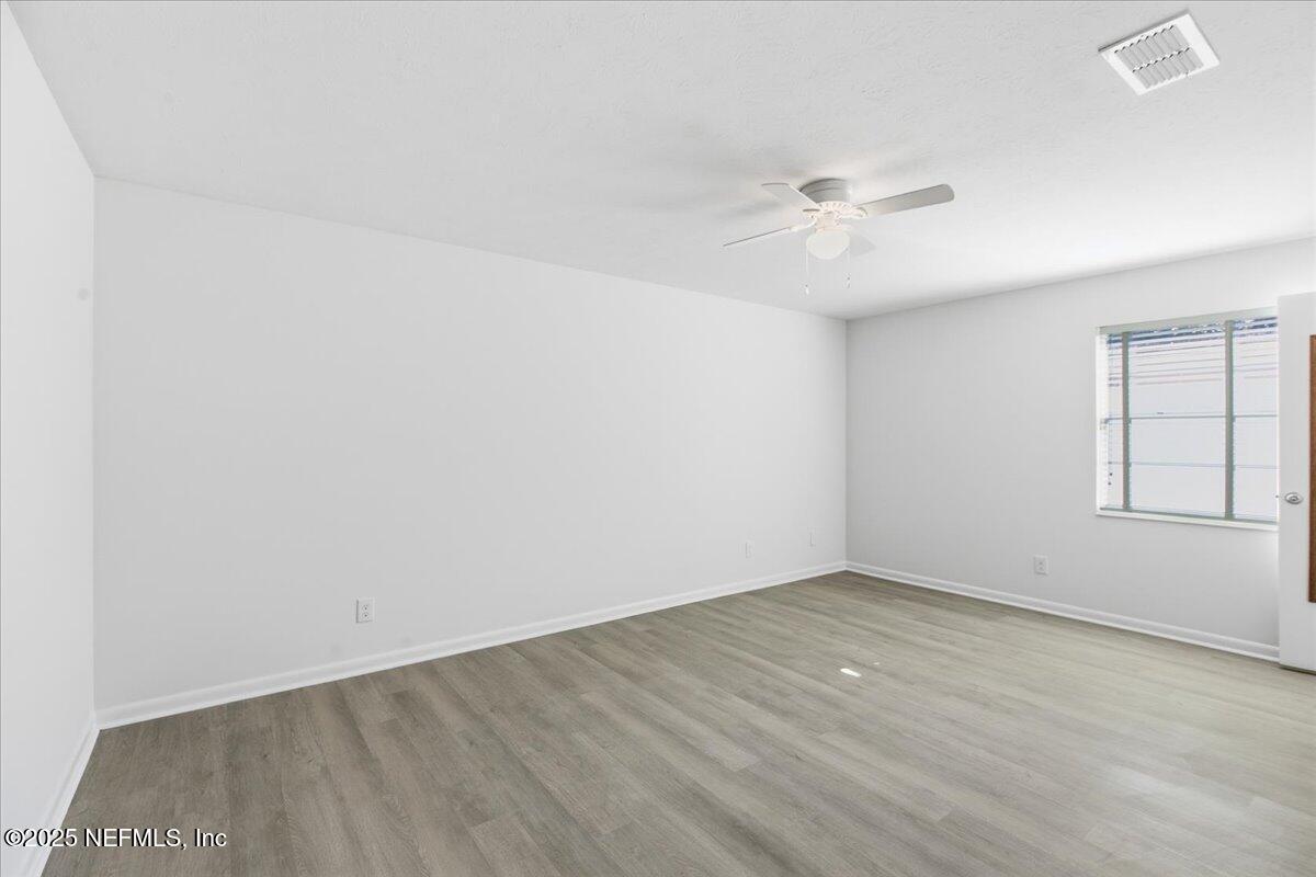 3767 Heath Road Jacksonville, FL 32277 - Photo 15 of 23 an empty room with a ceiling fan and a window