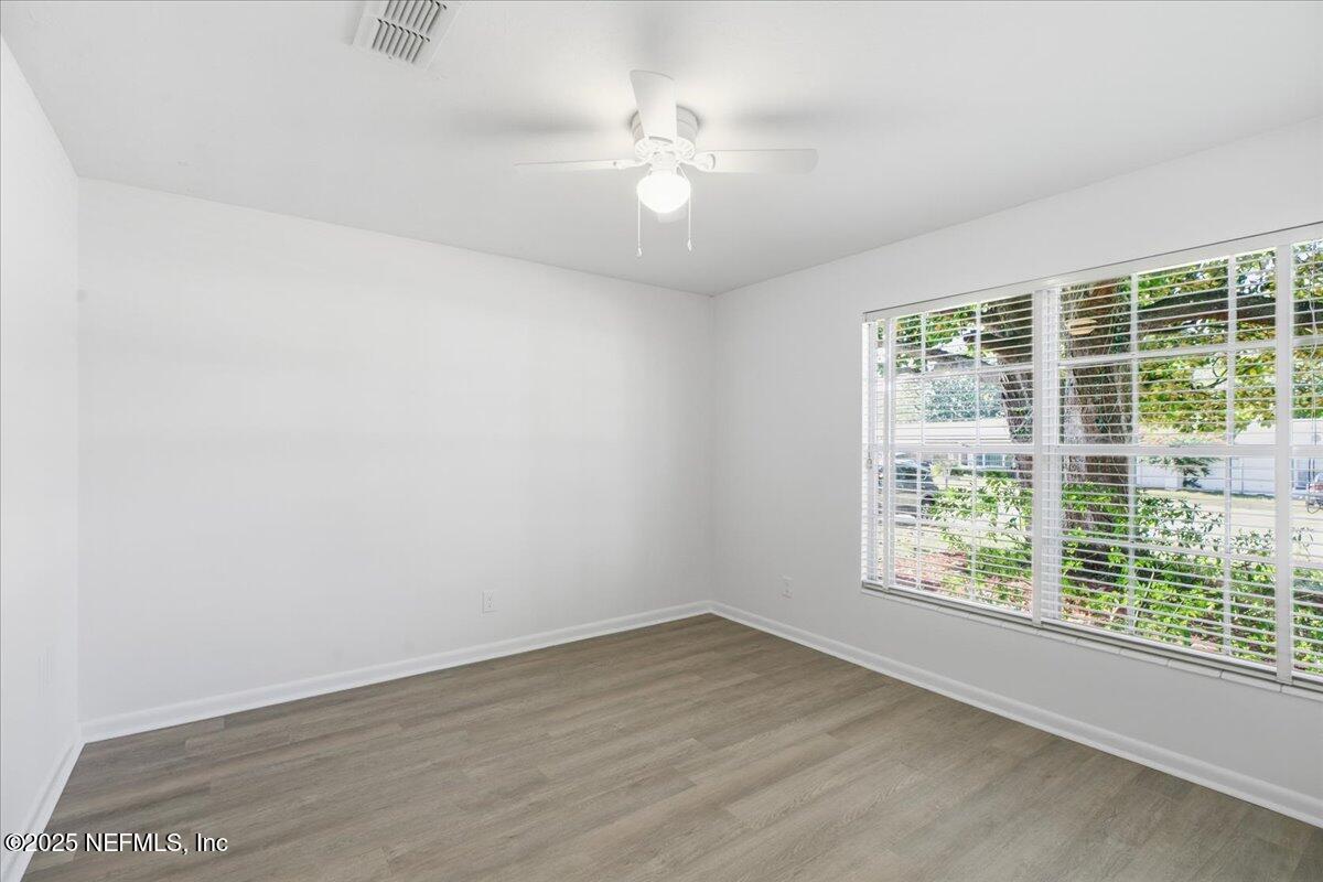 3767 Heath Road Jacksonville, FL 32277 - Photo 17 of 23 an empty room with wooden floor and windows