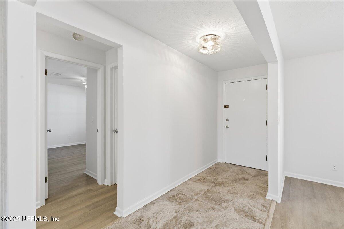 3767 Heath Road Jacksonville, FL 32277 - Photo 3 of 23 a view of a hallway to rooms