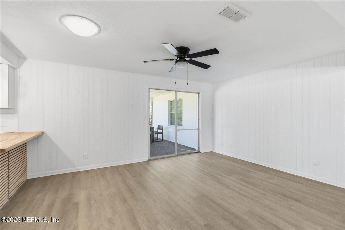 3767 Heath Road Jacksonville, FL 32277 - Photo 6 of 23 wooden floor in an empty room with a window
