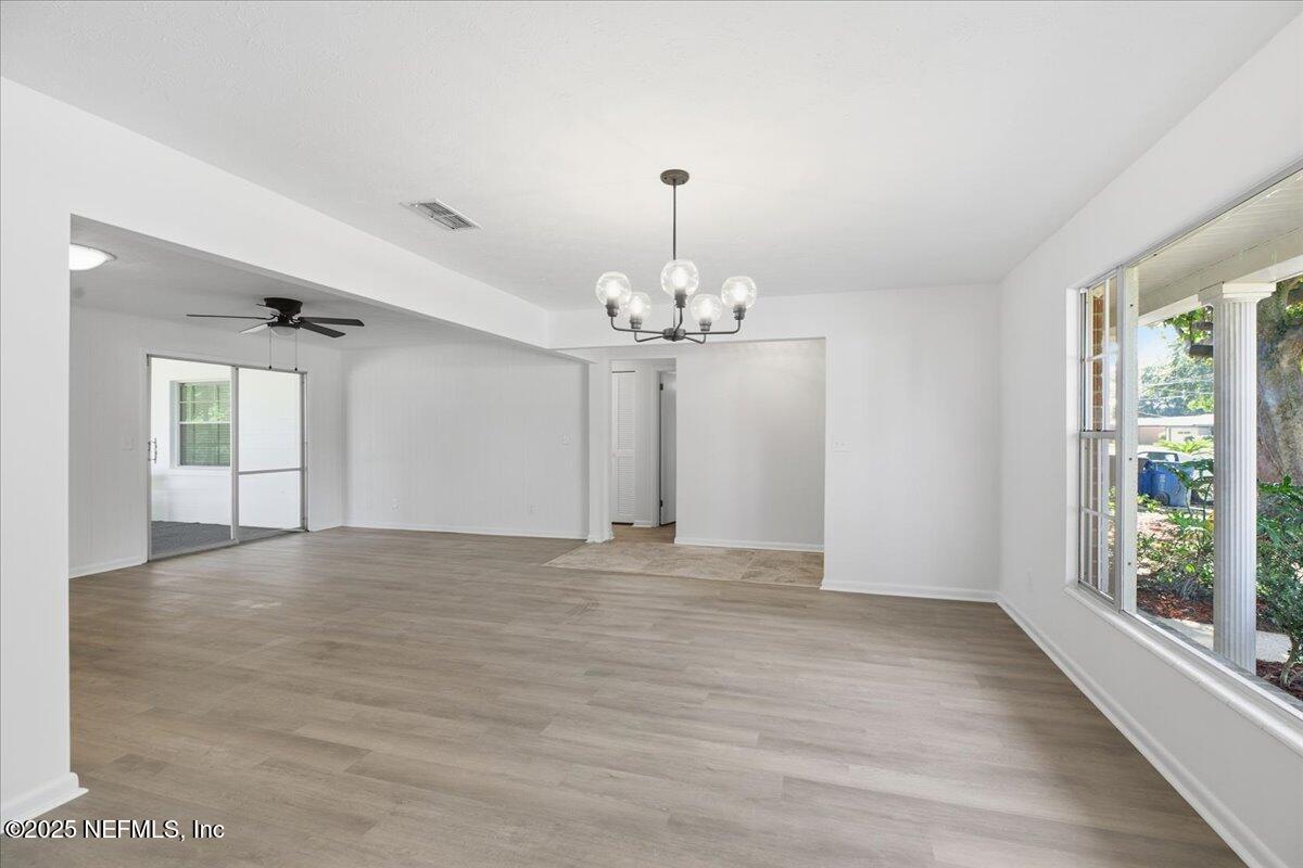 3767 Heath Road Jacksonville, FL 32277 - Photo 9 of 23 a view of an empty room with window and chandelier fan