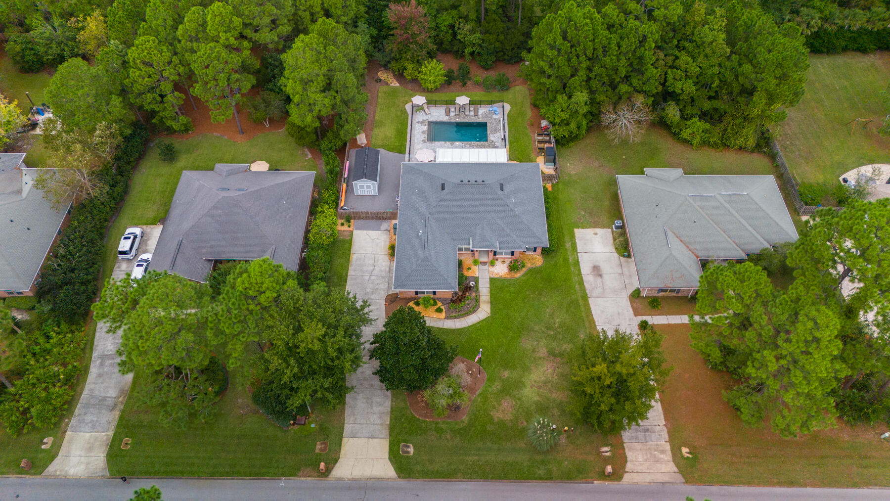 an aerial view of a house with garden space and street view