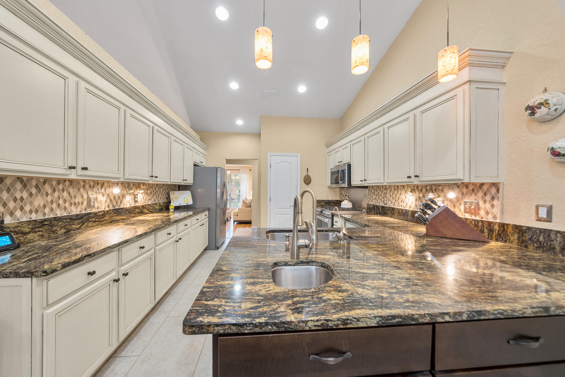 130 Shipwreck Road Santa Rosa Beach, FL 32459 - Photo 12 of 76 a kitchen with kitchen island granite countertop a sink stove and cabinets