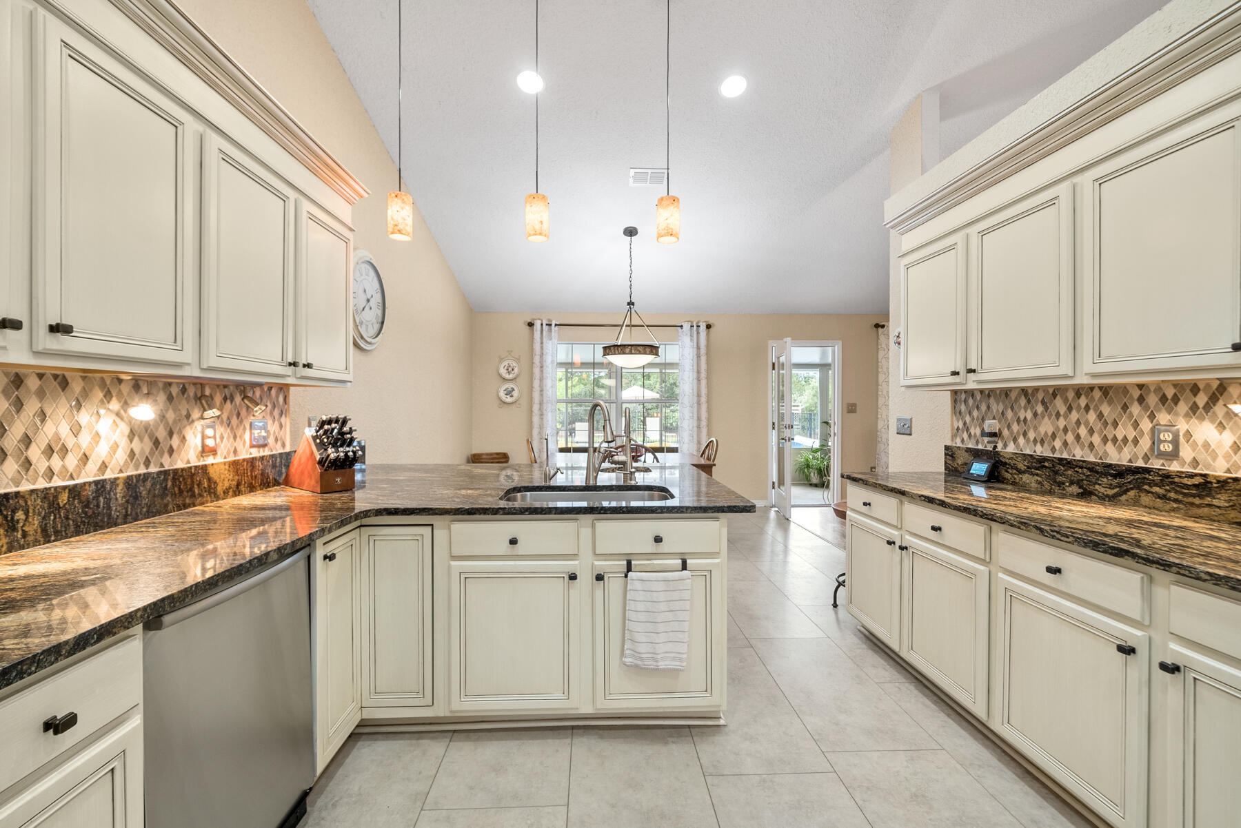 130 Shipwreck Road Santa Rosa Beach, FL 32459 - Photo 13 of 76 a kitchen with granite countertop white cabinets and white appliances