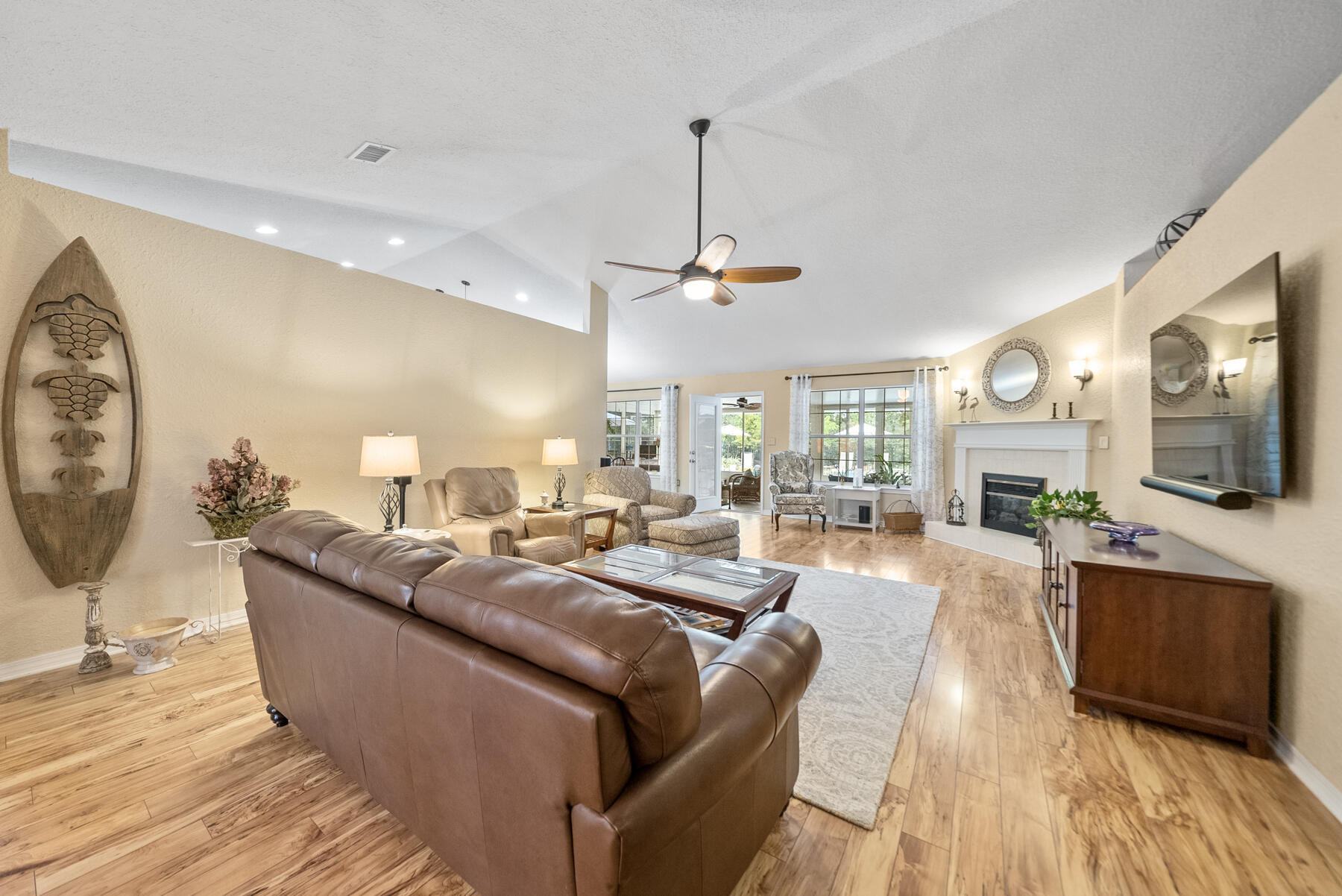 130 Shipwreck Road Santa Rosa Beach, FL 32459 - Photo 6 of 76 a living room with furniture a fireplace and a flat screen tv