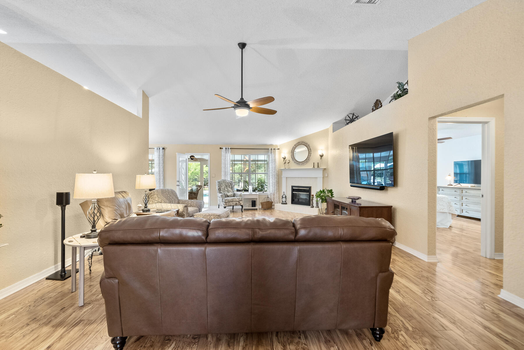 130 Shipwreck Road Santa Rosa Beach, FL 32459 - Photo 9 of 76 a living room with furniture a chandelier and a flat screen tv