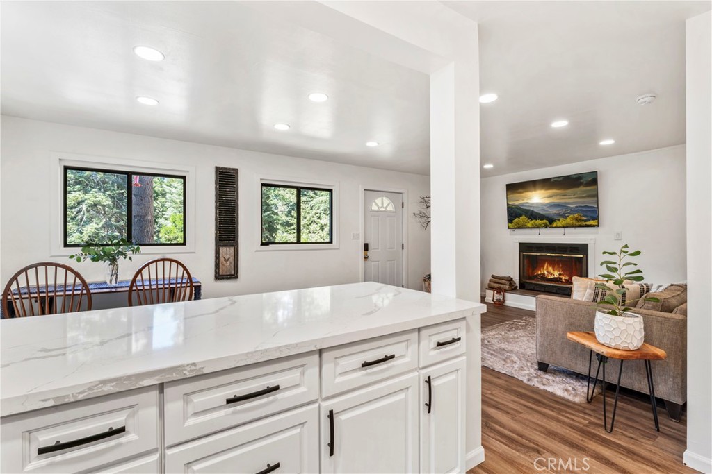 899 Blue Ridge Drive Lake Arrowhead, CA 92385 - Photo 11 of 49 a view of living room kitchen with furniture and fireplace