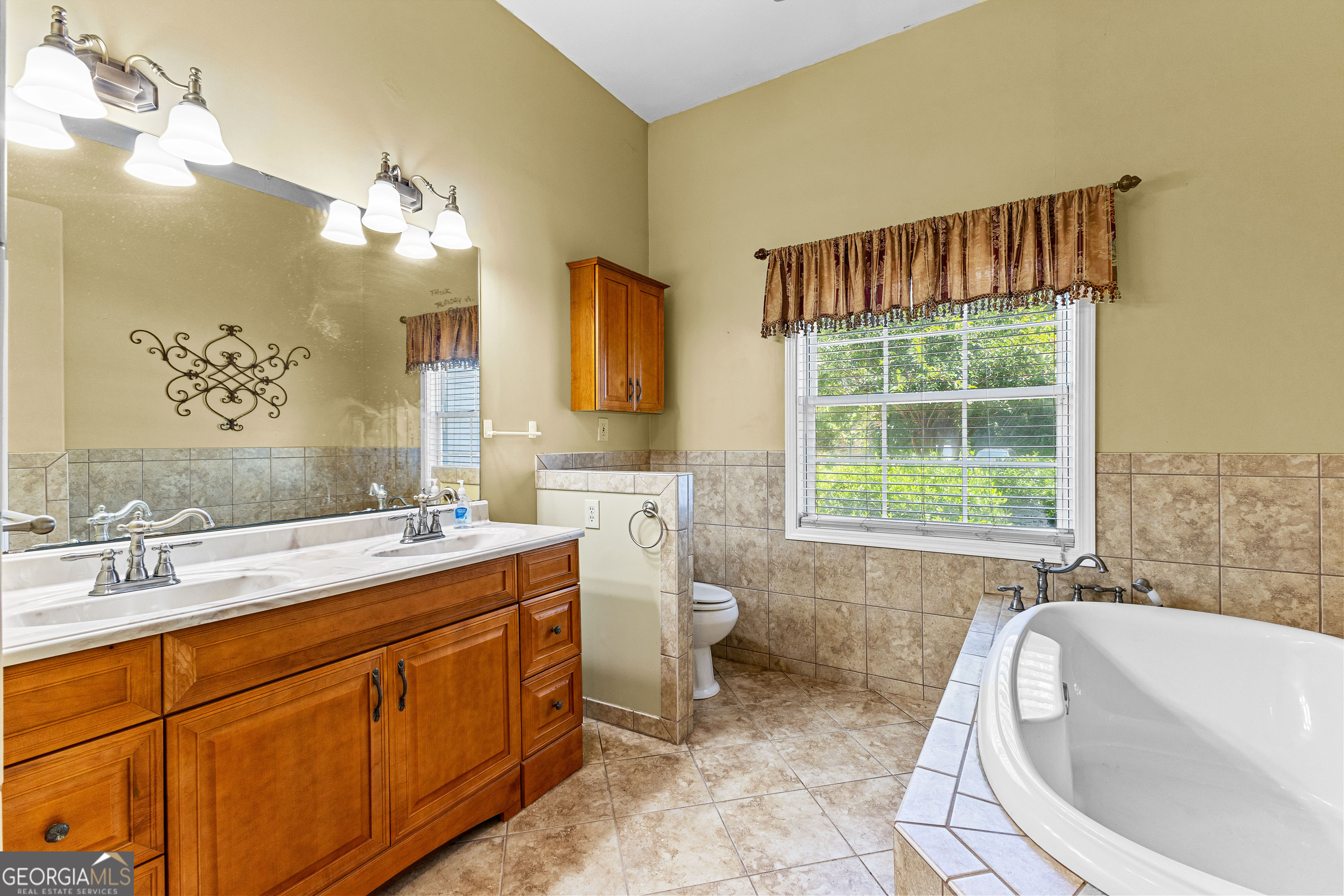20 Conkle Road Hampton, GA 30228 - Photo 19 of 56 a spacious bathroom with a tub sink and mirror