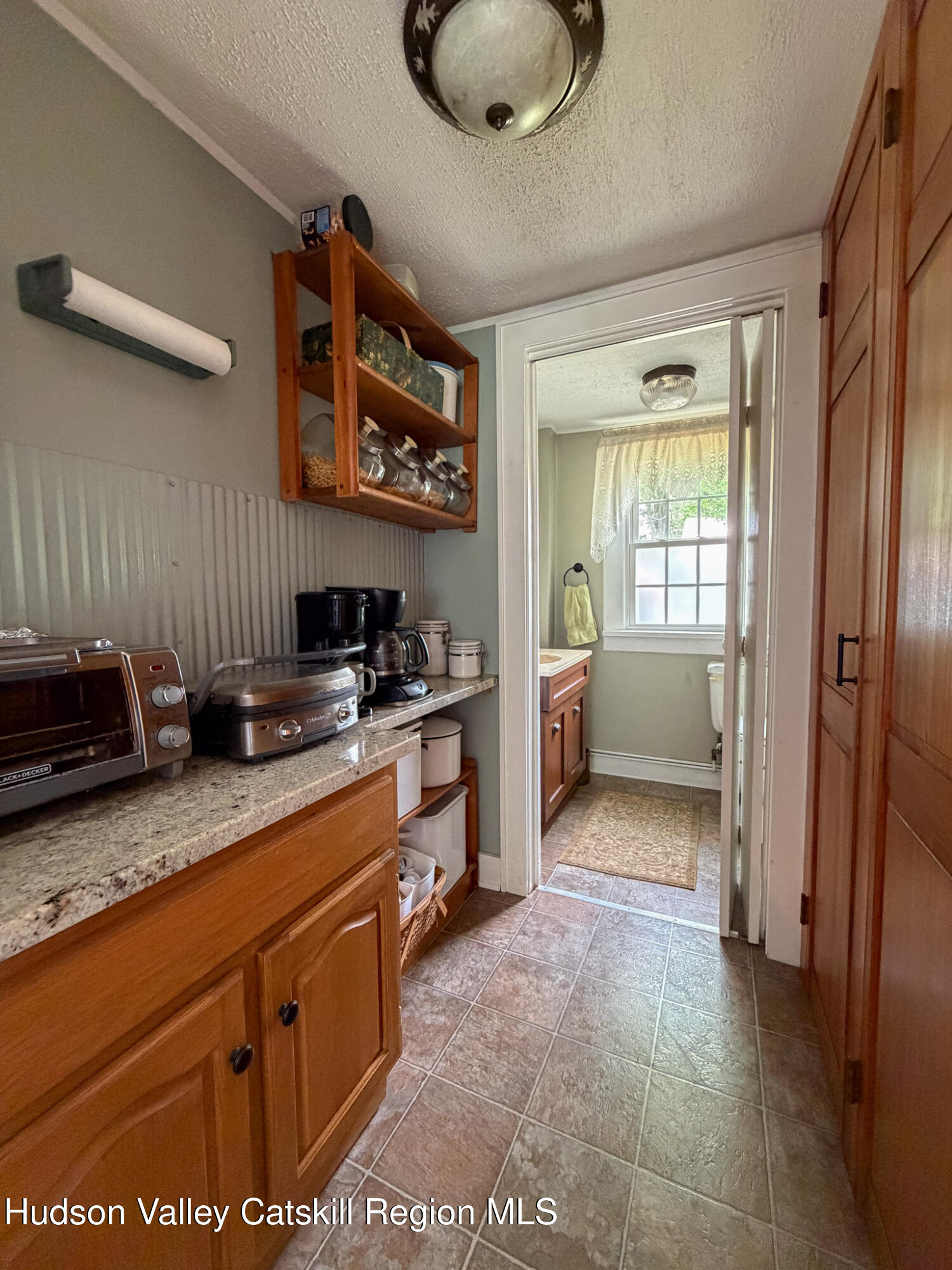 221 Camp Medusa Road Rensselaerville, NY 12120 - Photo 12 of 57 a kitchen with stainless steel appliances granite countertop a stove a sink and a refrigerator