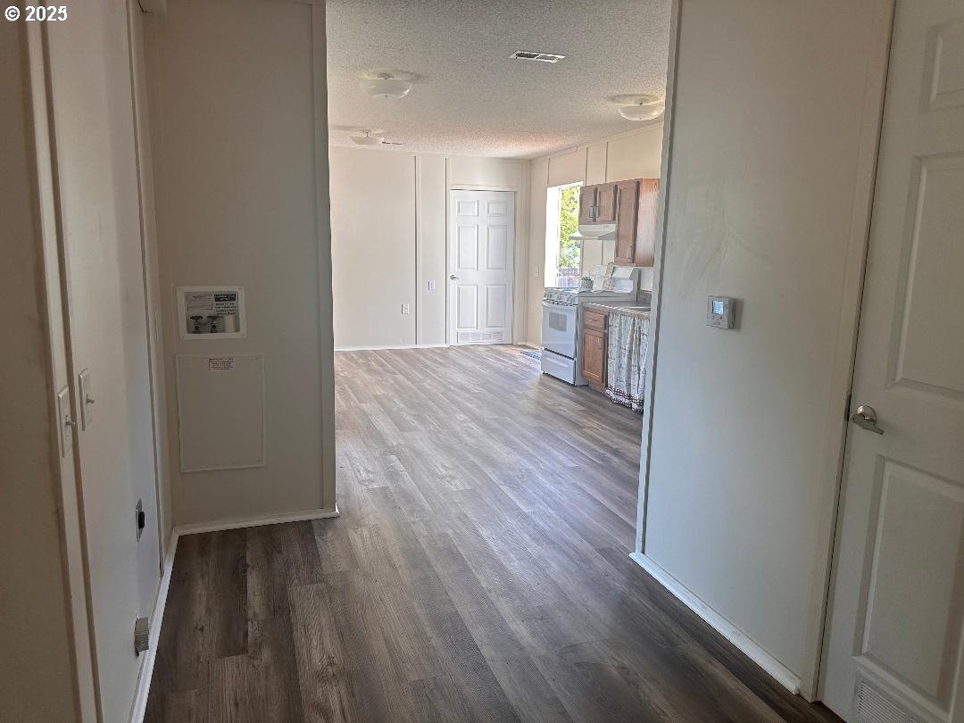5000 Northeast Stephens Street, Unit 39 Roseburg, OR 97470 - Photo 5 of 9 a view of a hallway with wooden floor and a bathroom