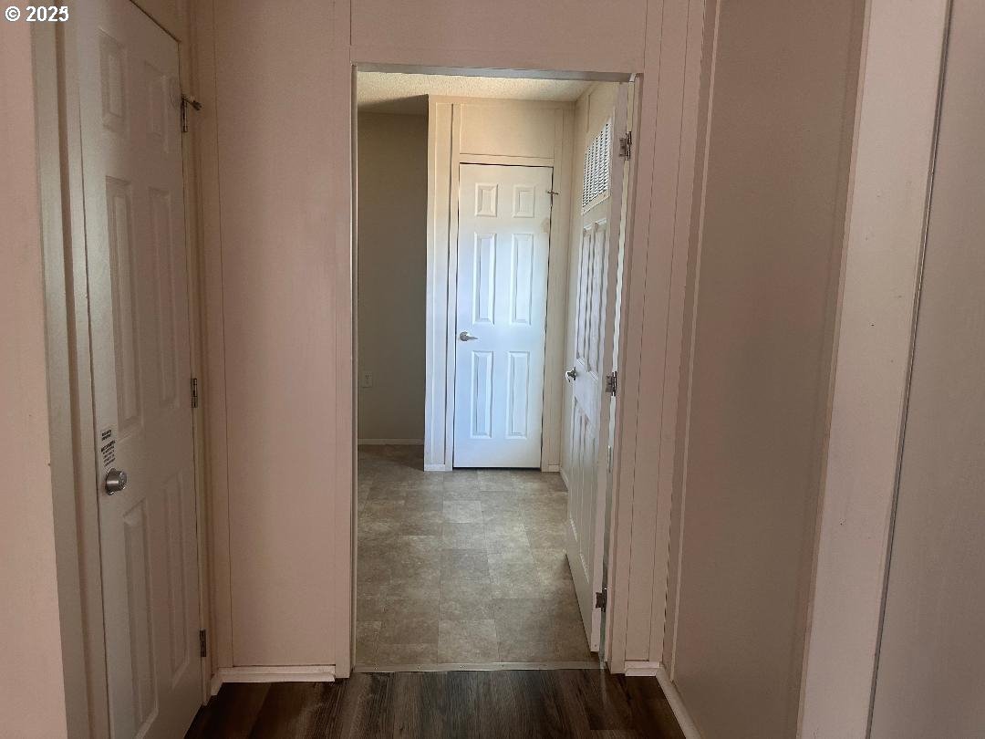 5000 Northeast Stephens Street, Unit 39 Roseburg, OR 97470 - Photo 7 of 9 a view of a hallway with wooden floor