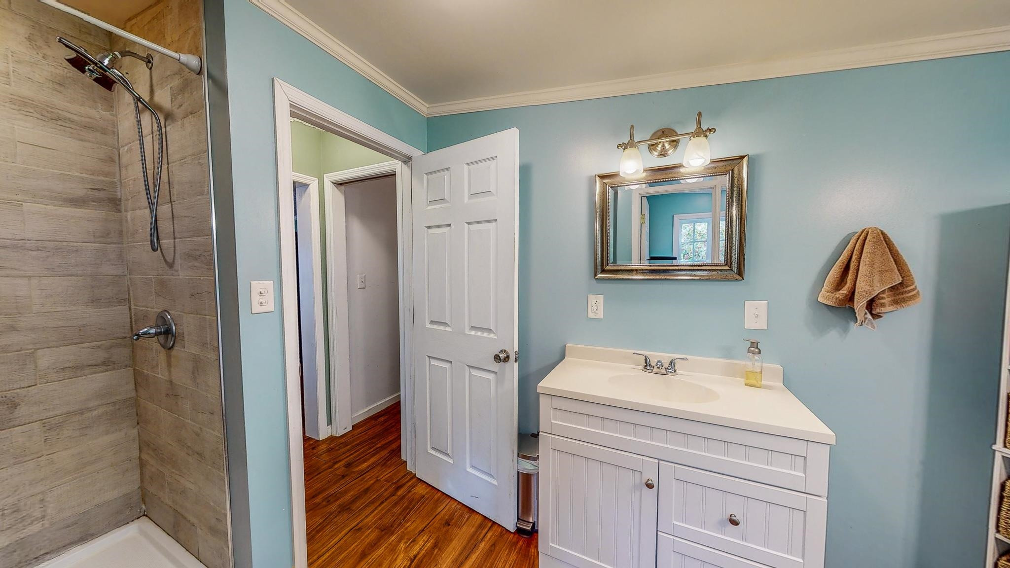 5311 Hurdle Mills Road Roxboro, NC 27574 - Photo 29 of 51 a bathroom with a sink a vanity and a mirror